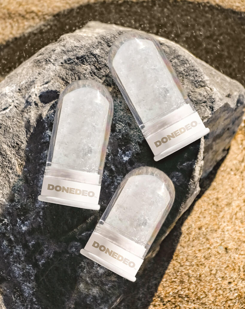 DONEDEO FAVORITE THINGS bundle with three natural deodorant crystal sticks displayed on a rock, representing a popular multipack for long-lasting freshness