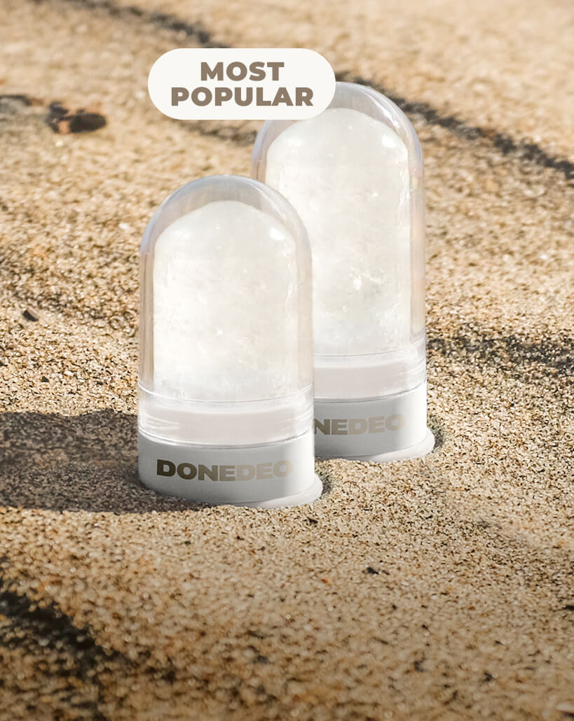DONEDEO FRESH START bundle featuring two natural deodorant crystal sticks on sand, ideal for first-time users seeking clean, effective odor protection